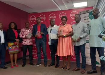 Group of agricultural finance partners holding awards at a GIRSAL event in Ghana