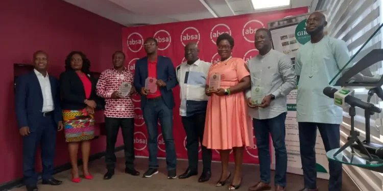 Group of agricultural finance partners holding awards at a GIRSAL event in Ghana