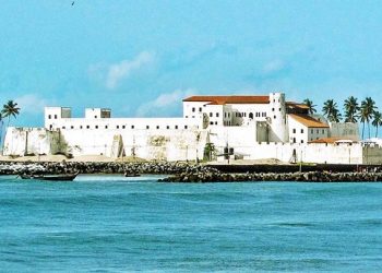 Elmina Ghana coastal town with fishing boats and historic castle background