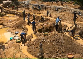 Illegal mining (galamsey) site with disturbed land and excavation activity.
