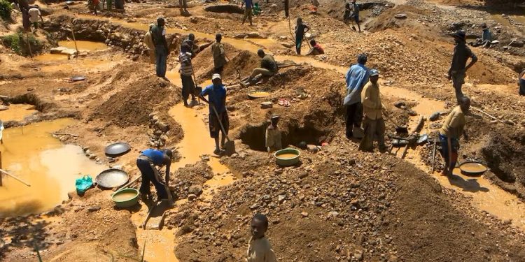 Illegal mining (galamsey) site with disturbed land and excavation activity.